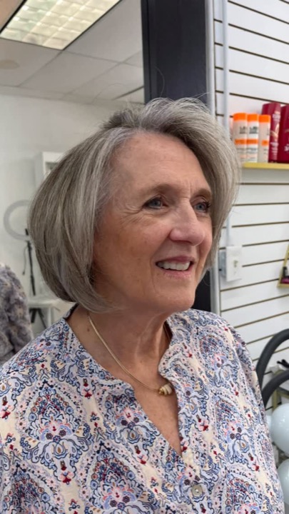 Client with a fresh silver bob haircut at the salon